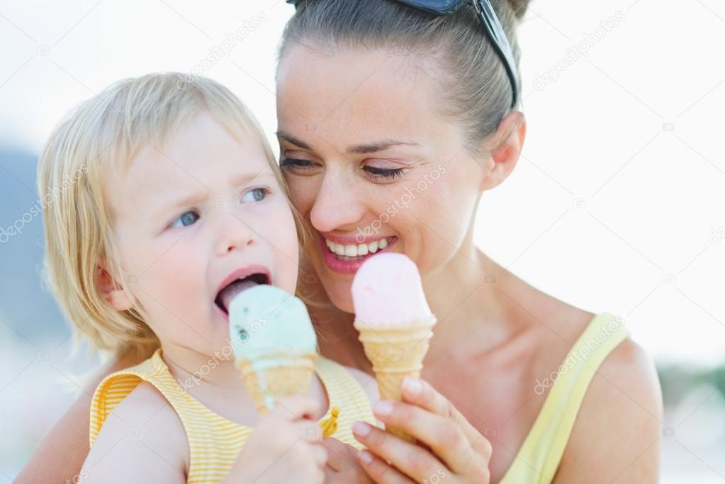 Portrait of happy mother and baby eating ice cream