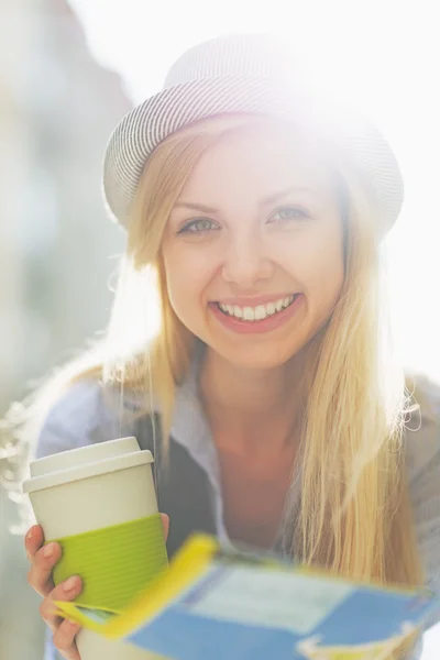 Girl with map and cup of hot beverage — Stock Photo, Image