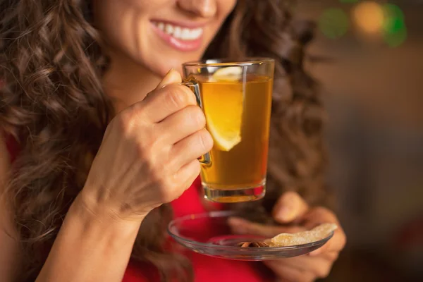 Happy young woman drinking ginger tea with lemon — Stock Photo, Image