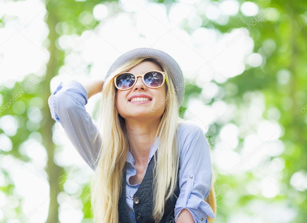 Happy hipster girl rejoicing in the park