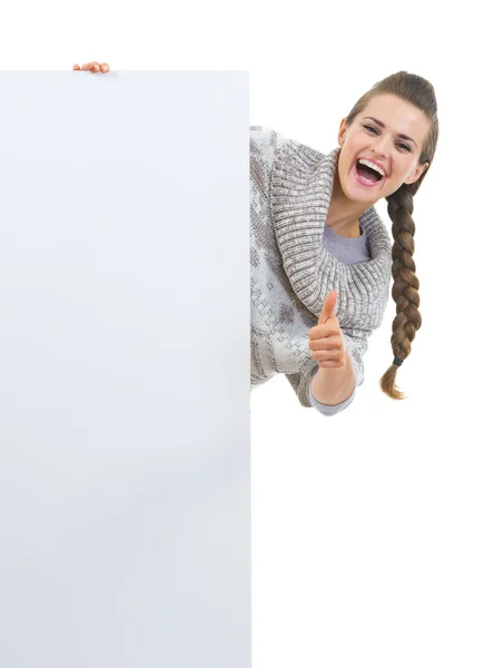 Woman in sweater with blank billboard — Stock Photo, Image