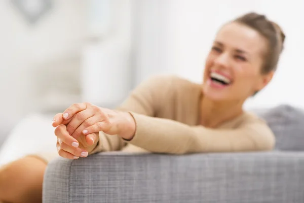 Woman sitting on sofa — Stock Photo, Image