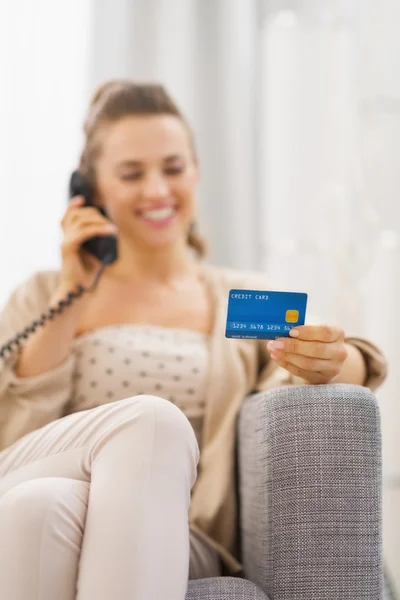 Woman with credit card and a phone — Stock Photo, Image