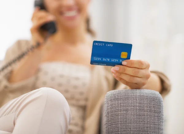 Woman with credit card and a phone — Stock Photo, Image