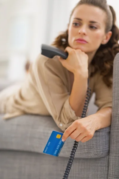 Woman with credit card and a phone — Stock Photo, Image