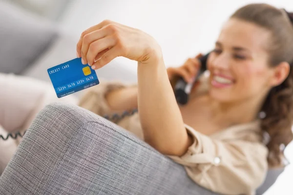 Woman with credit card and a phone — Stock Photo, Image