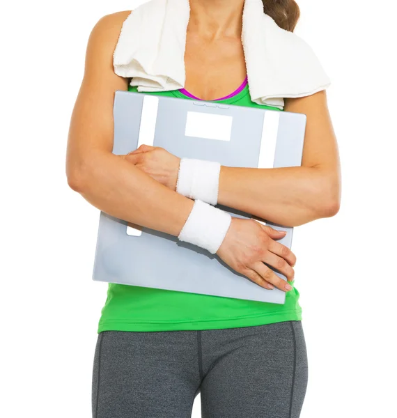 Closeup on fitness woman hugging scales — Stock Photo, Image