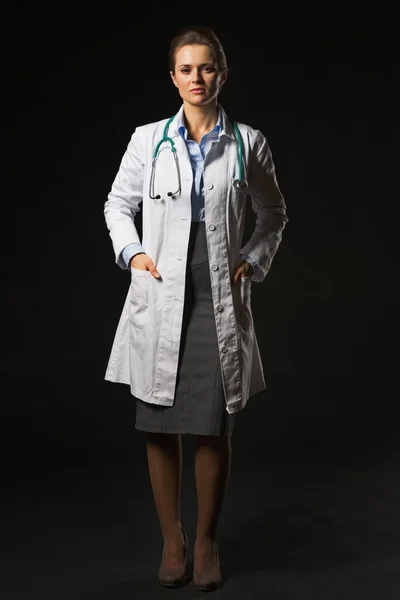 Full length portrait of doctor woman isolated on black — Stock Photo, Image