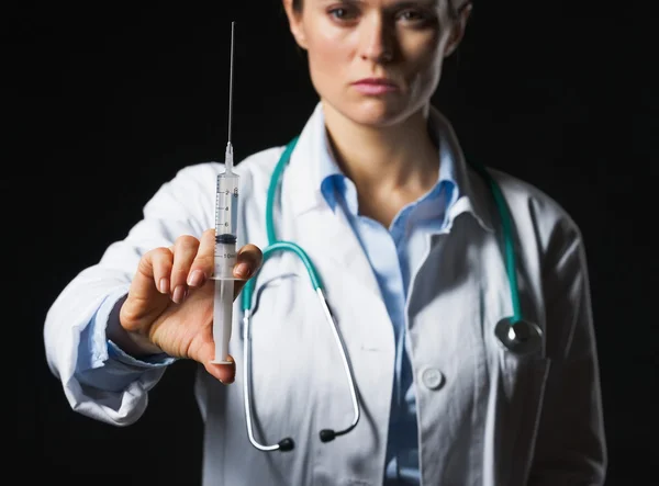 Closeup on syringe in hand of doctor woman isolated on black — Stock Photo, Image