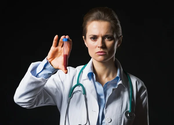 Mujer doctora mostrando tubo de ensayo sobre fondo negro —  Fotos de Stock