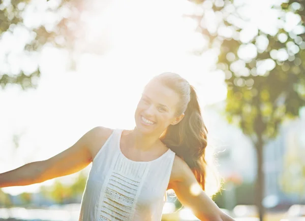 Jonge vrouw met plezier in stadspark glimlachen — Stockfoto