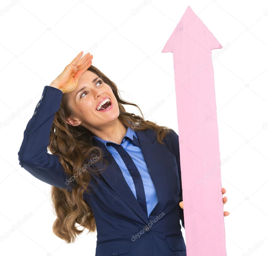 Smiling business woman pointing with arrow up
