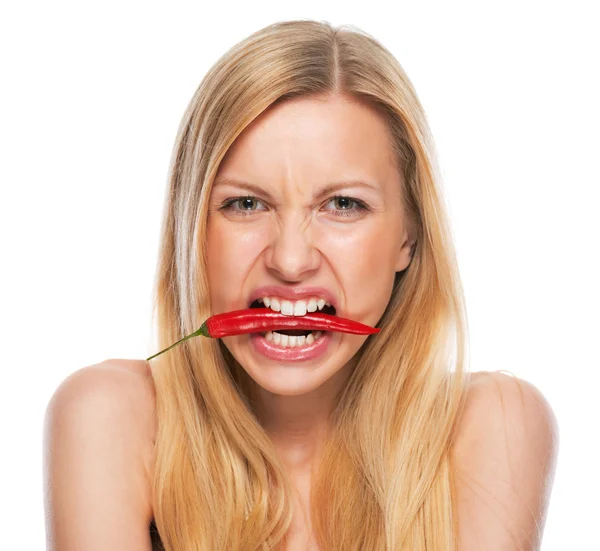 Teenage girl with red chili pepper in mouth — Stock Photo, Image