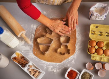 Young housewife making christmas cookies with dough cutter clipart