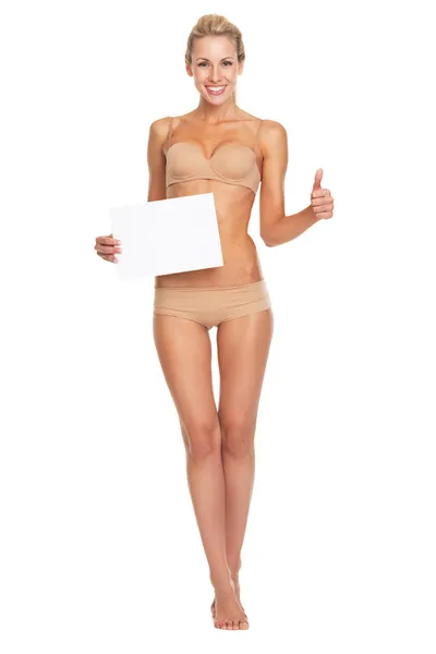 Vrouw in lingerie tonen blanco papier blad en duimen omhoog — Stockfoto