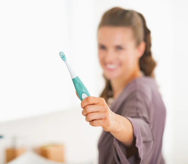 Primer plano en el cepillo de dientes en la mano de la mujer joven —  Fotos de Stock