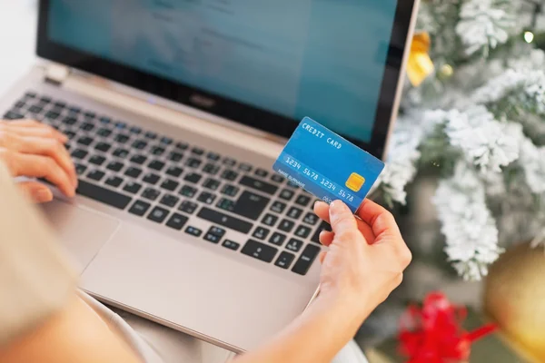 Gros plan sur la jeune femme faisant des achats en ligne près de l'arbre de Noël — Photo