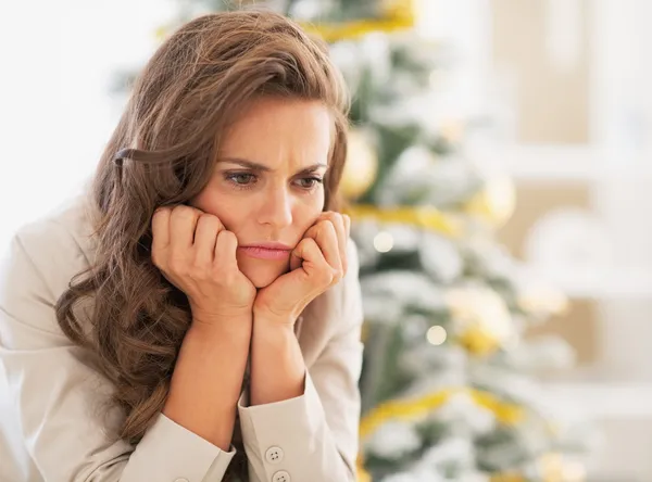 Portret van gefrustreerd jonge vrouw in de buurt van de kerstboom — Stockfoto