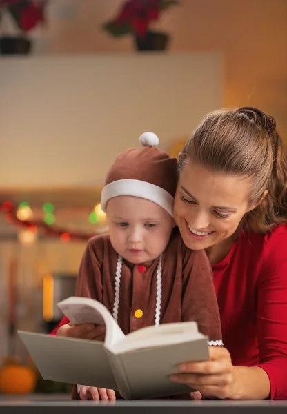 Mutlu anne ve bebek Noel kostümü kitap okuma — Stok fotoğraf