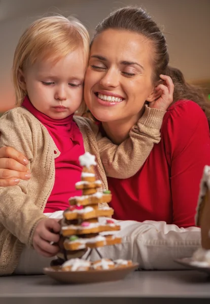 Portrait of happy mother and baby and cookie christmas tree — Stock Photo, Image