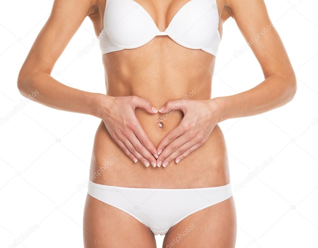 Closeup on young woman in lingerie put hands on stomach