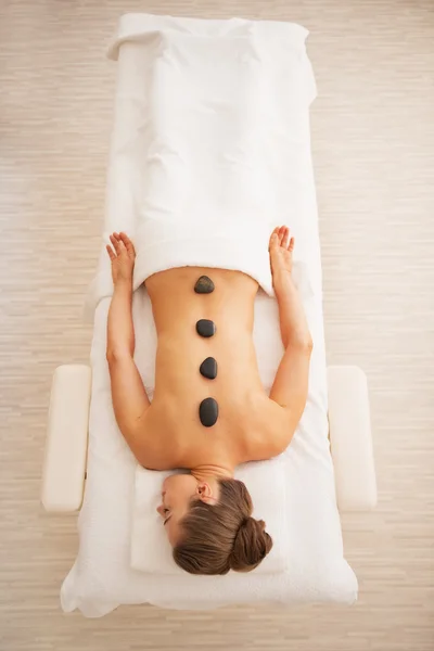 Young woman receiving hot stone massage — Stock Photo, Image