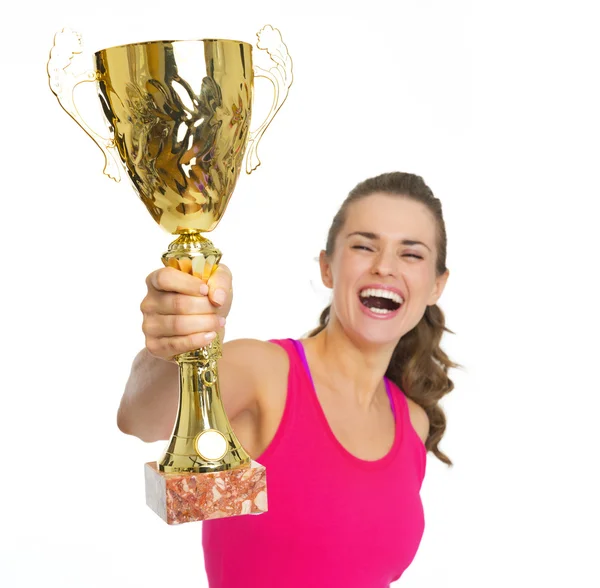 Щаслива фітнес молода жінка з золотим кубком трофею радіє — стокове фото