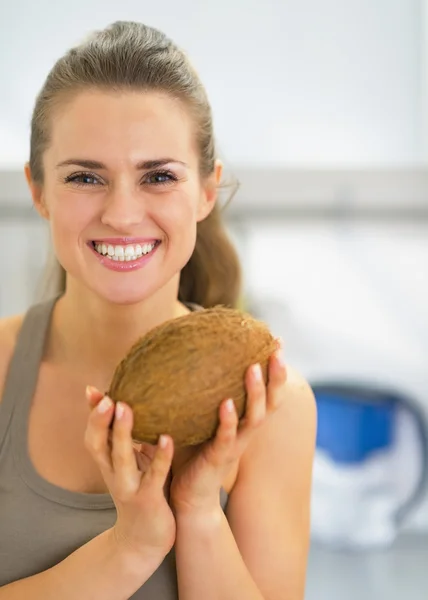 Happy young woman holding coconut — Stock Photo, Image