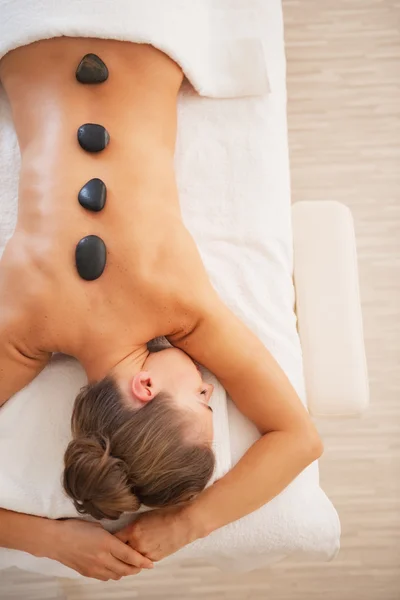 Young woman receiving hot stone massage — Stock Photo, Image