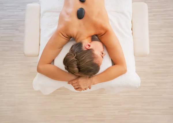 Young woman laying on massage table — Stock Photo, Image