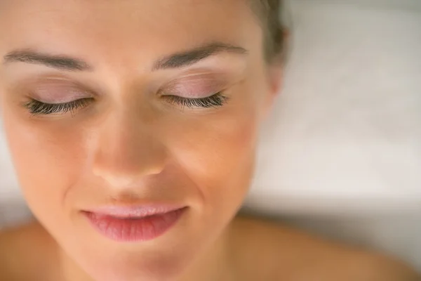 Closeup on young woman laying on massage table — Stock Photo, Image