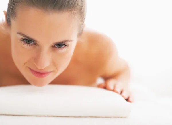 Portrait of young woman laying on massage table — Stock Photo, Image