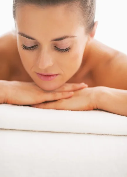 Portrait of young woman laying on massage table — Stock Photo, Image