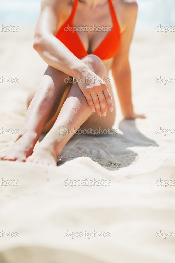 Closeup on young woman sitting on beach