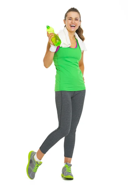 Full length portrait of smiling fitness young woman with bottle — Stock Photo, Image