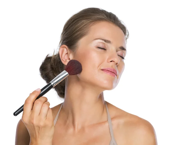 Happy young woman enjoying using brush — Stock Photo, Image