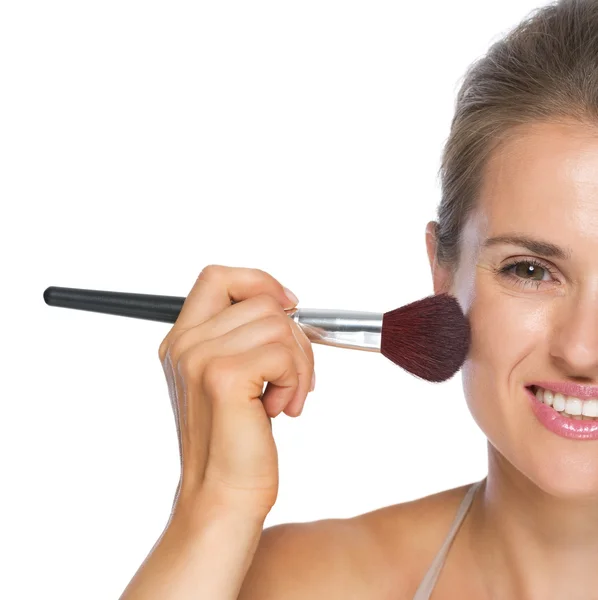 Happy young woman using brush — Stock Photo, Image