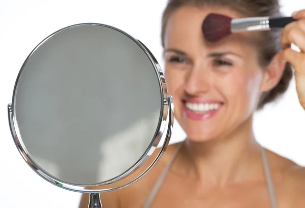 Closeup on young woman looking in mirror and makeup — Stock Photo, Image