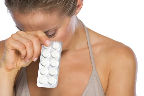 Stressed young woman with pills — Stock Photo, Image