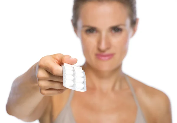 Closeup on young woman giving blistering package of pills — Stock Photo, Image