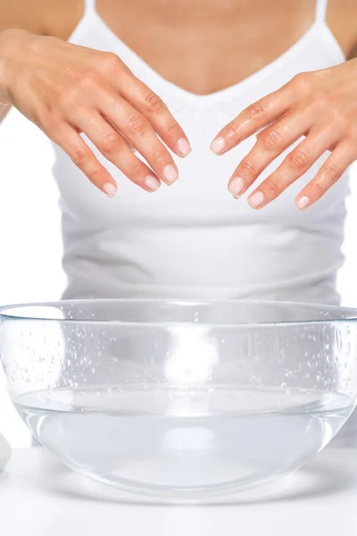 Closeup on young woman washing hands in glass bowl with water — Stock Photo, Image