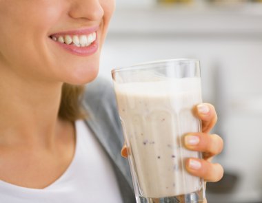 Closeup on young woman drinking smoothie clipart
