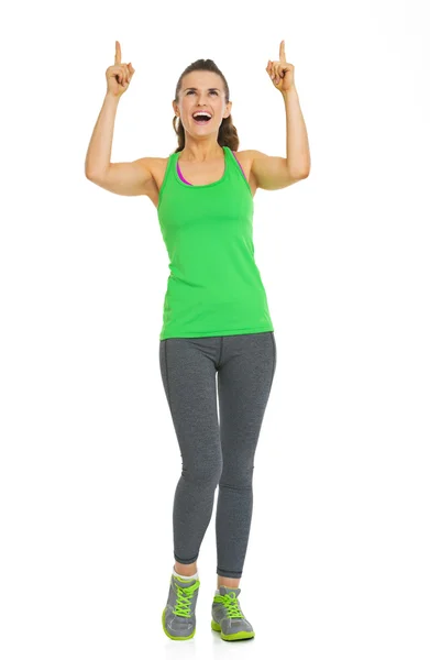 Full length portrait of fitness young woman pointing on copy spa — Stock Photo, Image