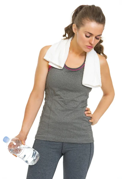 Tired fitness young woman with towel and bottle of water — Stock Photo, Image