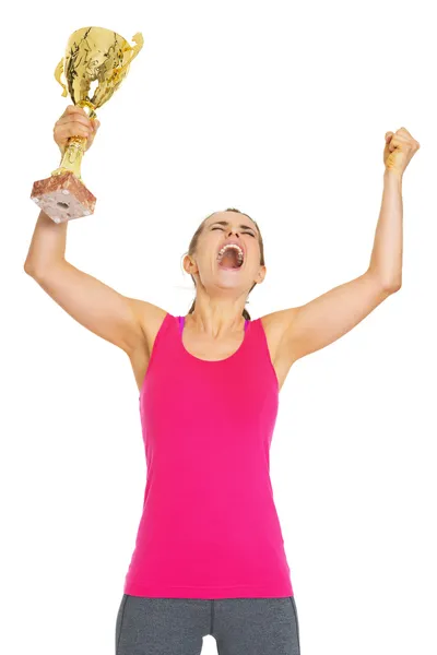 Happy fitness young woman with gold trophy cup rejoicing — Stock Photo, Image