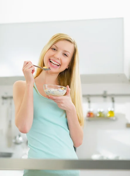 Frau isst Müsli in Küche — Stockfoto