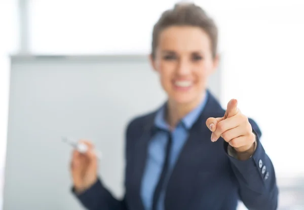 Business woman pointing on listener — Stock Photo, Image