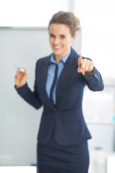 Business woman pointing on listener — Stock Photo, Image