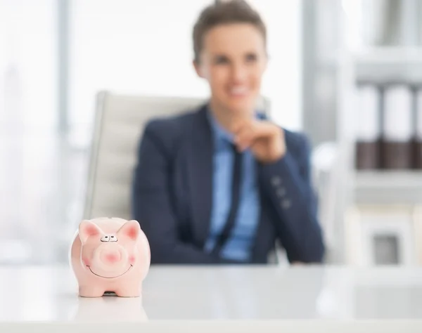 Piggy bank and stressed business woman — Stock Photo, Image