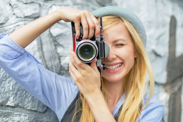 Hipster taking photo with retro camera Stock Image